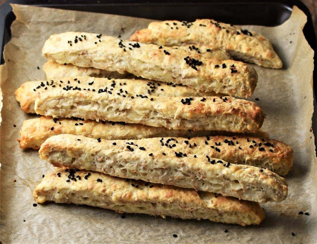 Side view of breadsticks on top of parchment.
