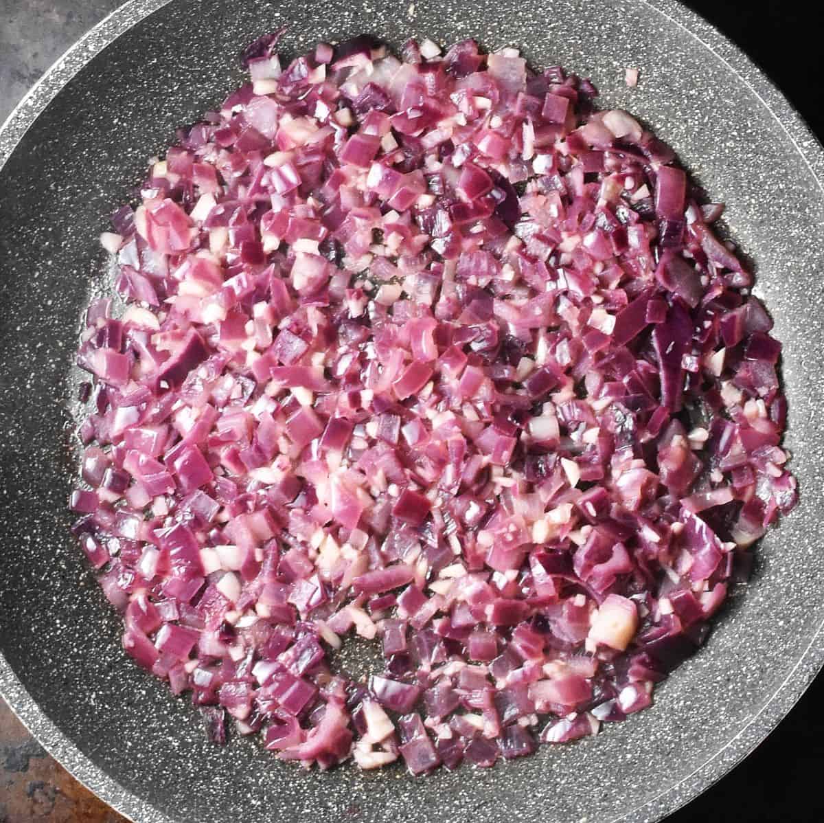 Sauteed red onion in large pan.