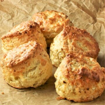 Side view of cauliflower scones on top of parchment.