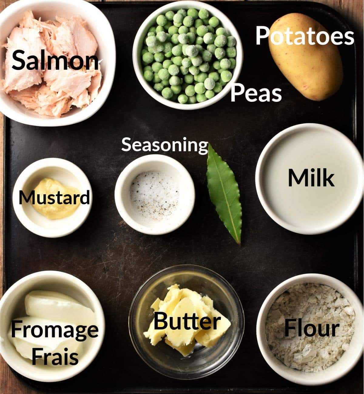 Salmon and potato bake ingredients in individual dishes.