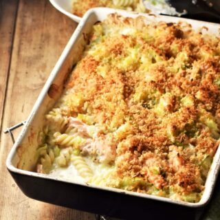 Side angle view of salmon pasta bake in rectangular dish.