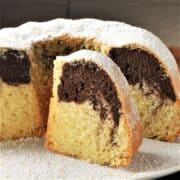 Side view of Polish babka slice and cake on white plate.